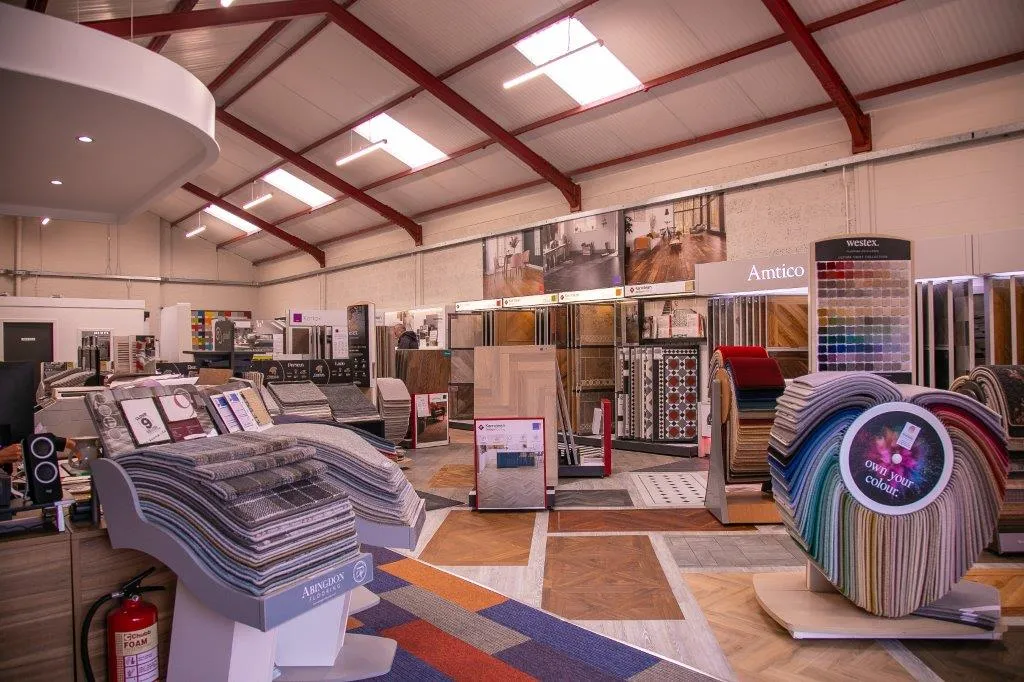 Wide selection of flooring materials displayed in a spacious showroom.