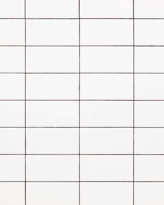 White grid tiles with black grout lines, creating a simple geometric pattern, ideal for modern interior design.