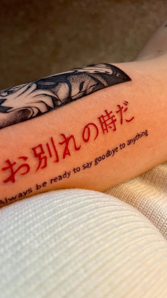 Tattoo with Japanese characters and English translation: Always be ready to say goodbye to anything on arm.