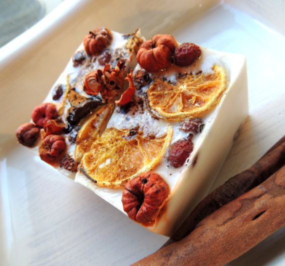 Decorative soap with dried oranges and spices on a white dish.