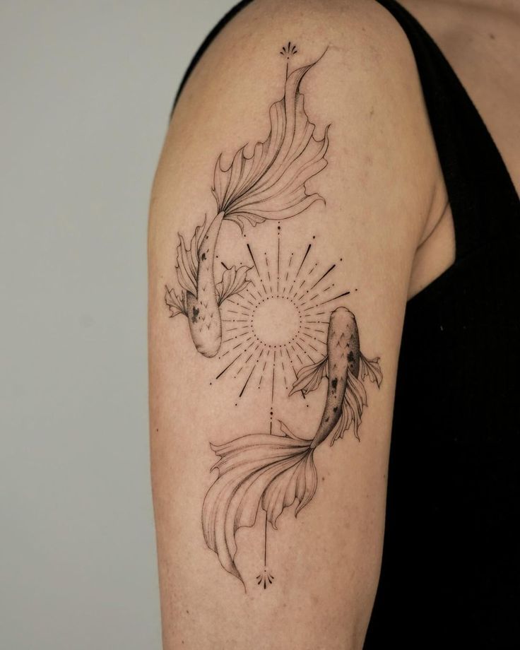 Koi fish tattoo on arm with intricate lines and sun design, symbolizing balance and harmony in black ink.