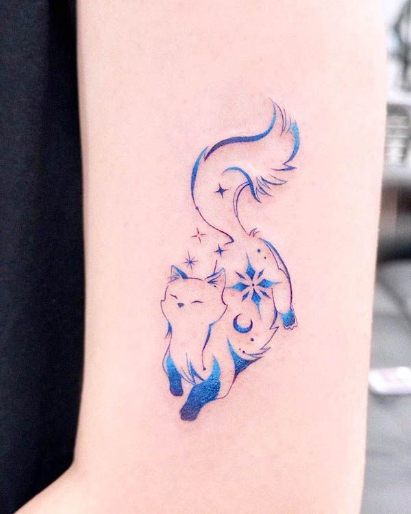 Stylized blue cat tattoo on arm, featuring stars and moon, blending elegance and celestial themes.