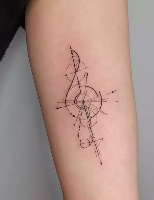 Geometric treble clef tattoo design on forearm with intricate lines and patterns.