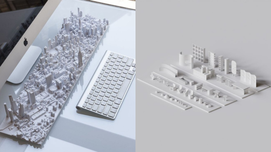 3D-printed cityscape keyboard with architectural miniatures, showcasing urban design on a desktop.