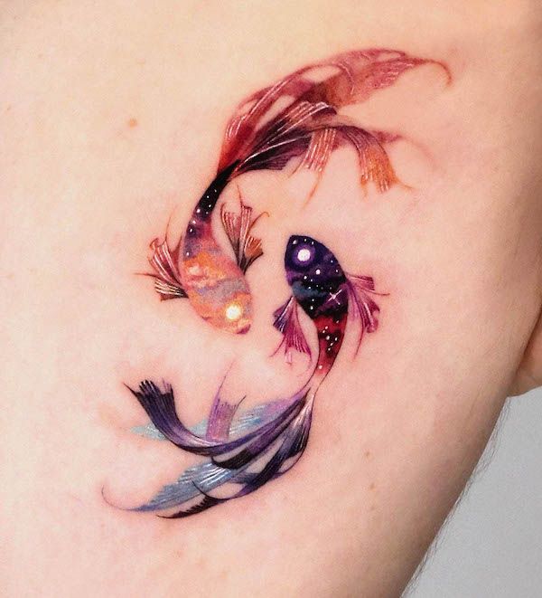 Colorful koi fish tattoo with galaxy design on skin, showcasing artistic ink detail and vibrant cosmic colors.