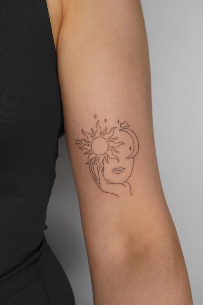 Minimalist sun and moon tattoo on arm, featuring abstract face line art and celestial elements.