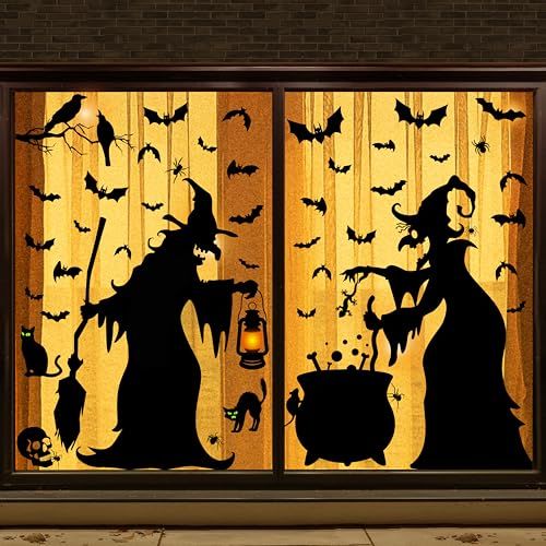 Silhouettes of witches with cauldron, bats, and cats in spooky Halloween window decoration with orange background.