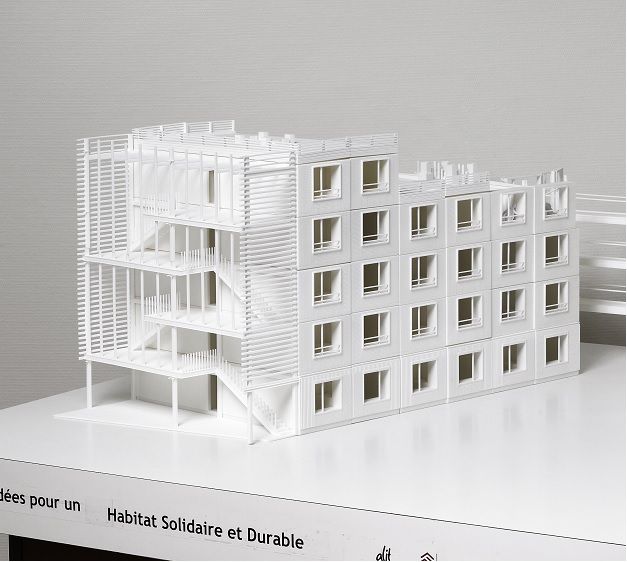 Architectural model of a modern, multi-story building highlighting sustainable and innovative design features.