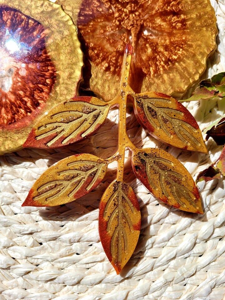 Autumn-themed resin leaf art with intricate details on a textured surface, capturing the essence of fall colors.