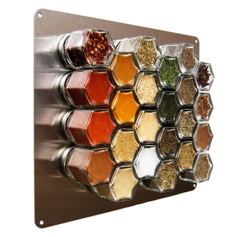 Wall-mounted hexagonal spice rack with various spices in glass jars for organized kitchen storage.