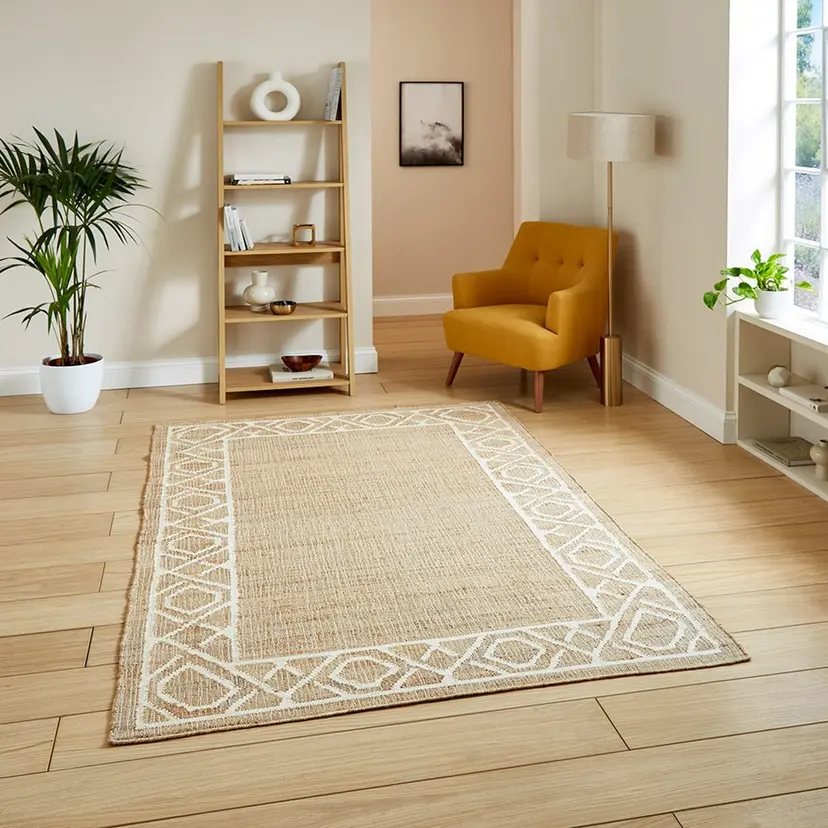 Modern living room with natural jute rug, mustard chair, and wooden shelf, creating a cozy, minimalist ambiance.