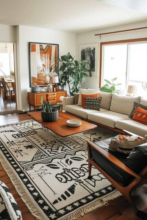 Cozy living room with bohemian decor, patterned rug, beige sofa, wooden furniture, and large plant by the window.