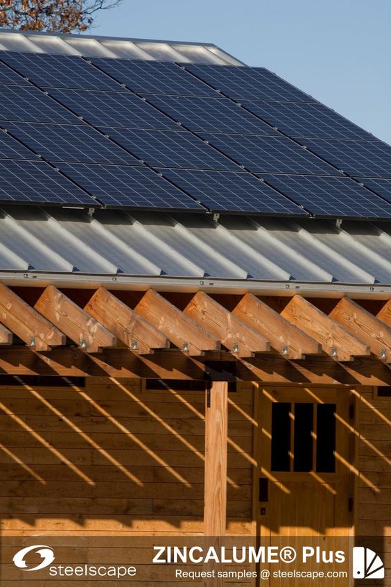 Solar panels on a metal roof showcasing ZINCALUME® Plus with wooden pergola. Steelscape branding visible.