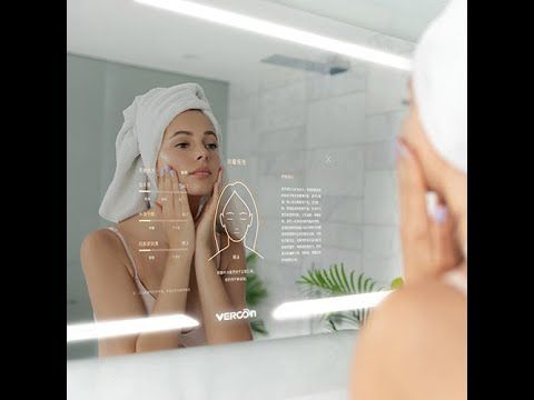 Woman using smart mirror skincare analysis, bathroom setting.