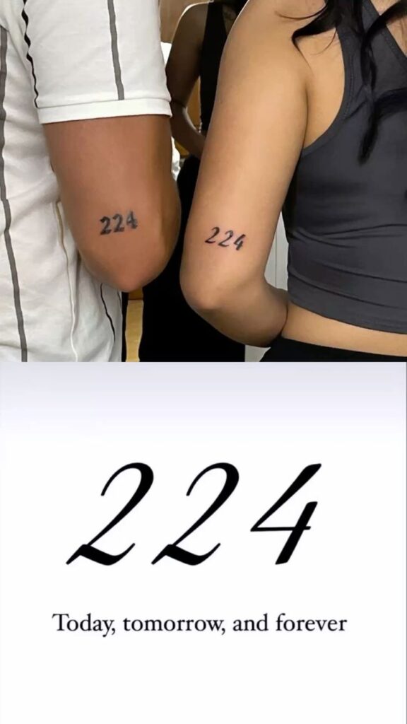 Matching 224 tattoos on arms symbolize Today, tomorrow, and forever commitment in stylized black ink.