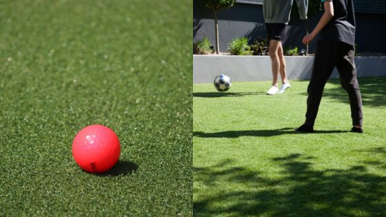 People playing soccer on a lawn with a close-up of a red ball in the foreground.