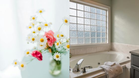 A calming bathroom with a jacuzzi tub and a vase of fresh flowers by a sunlit window, offering a relaxing ambiance.