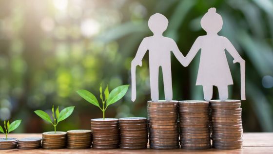 Paper figures on stacked coins with growing plants, symbolizing investment growth and financial planning for retirement.