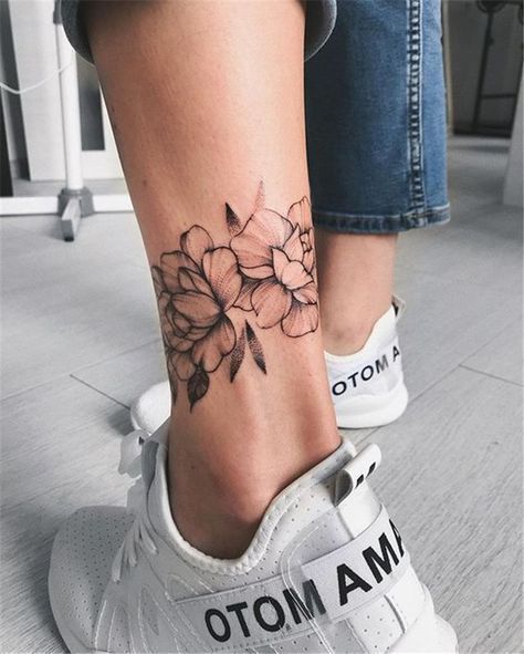 Floral ankle tattoo with sneakers and jeans background, showcasing intricate flower design. Perfect for tattoo inspiration.