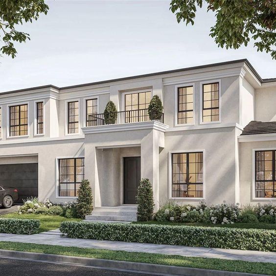 Modern two-story white house with landscaped front yard and large windows.