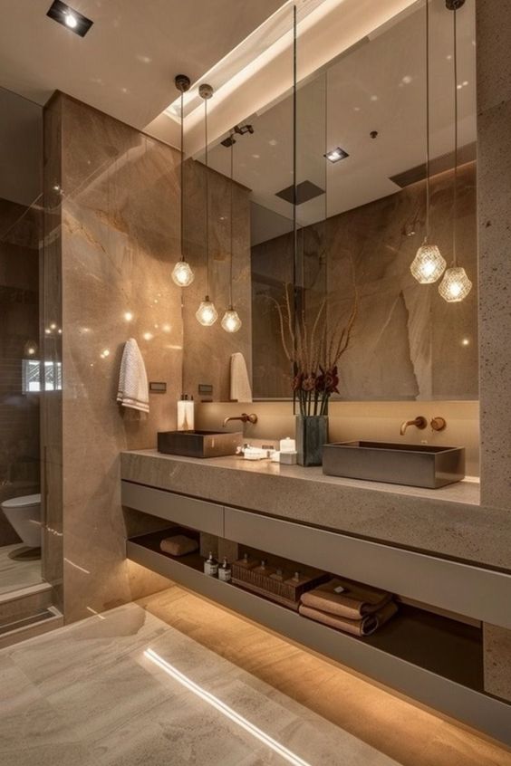 Luxurious modern bathroom with pendant lights, double sink, and elegant marble finishes.