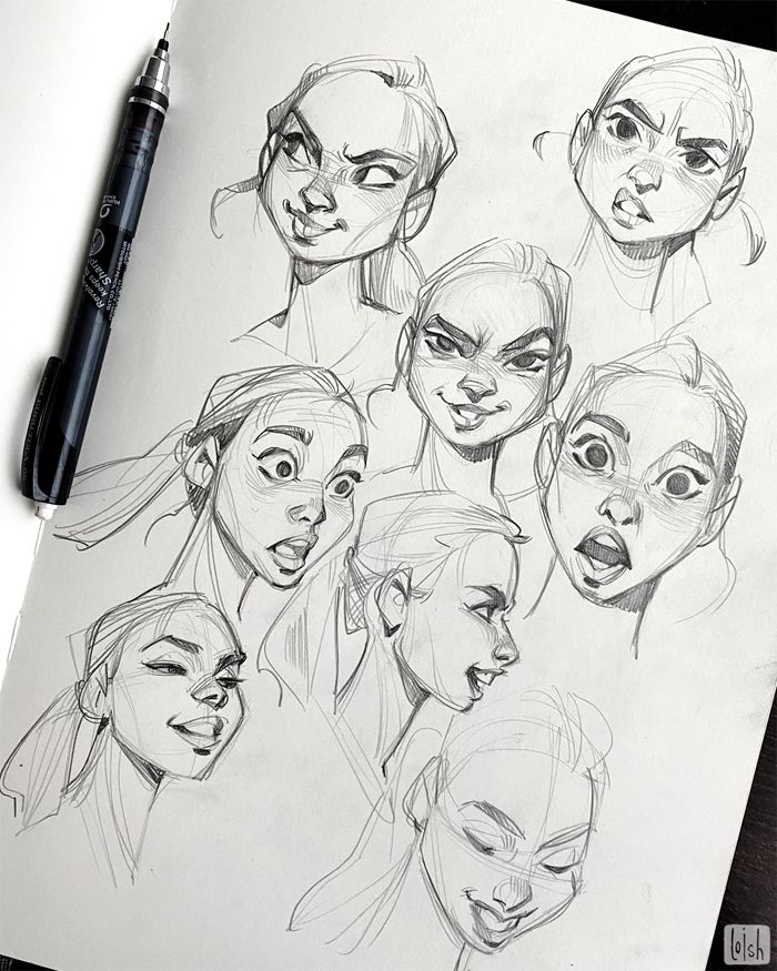 Pencil sketches of expressive female faces on paper, with a mechanical pencil beside them.