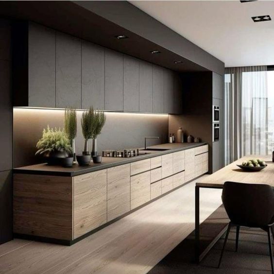 Modern kitchen with sleek wooden cabinets, potted plants, and a large window. Stylish, minimalist interior design.