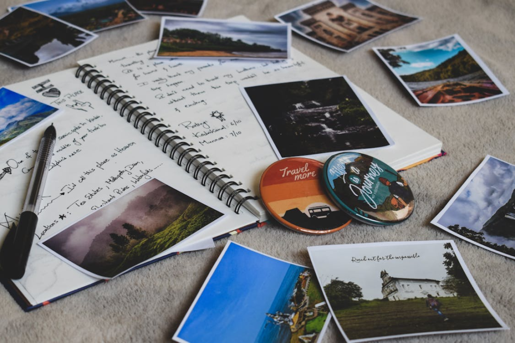 Travel memories scrapbook with photos, journal, pen, and inspiring badges, capturing adventures and wanderlust moments.