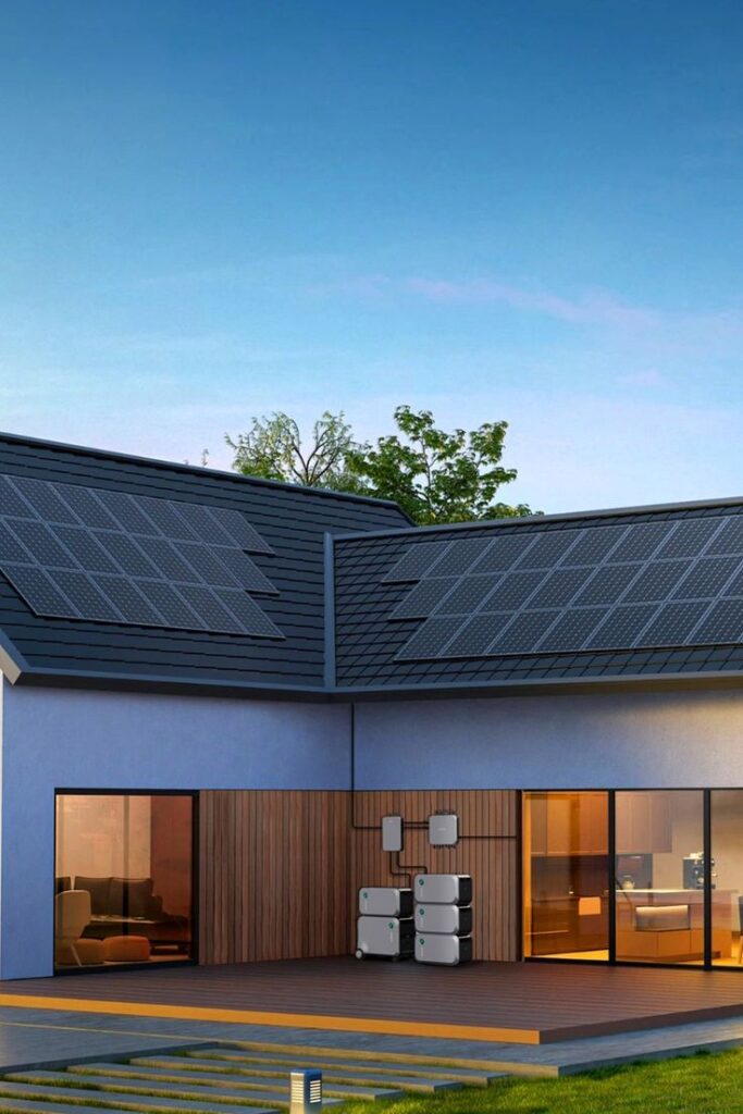 Modern house with rooftop solar panels and battery storage system, eco-friendly energy solution at sunset.