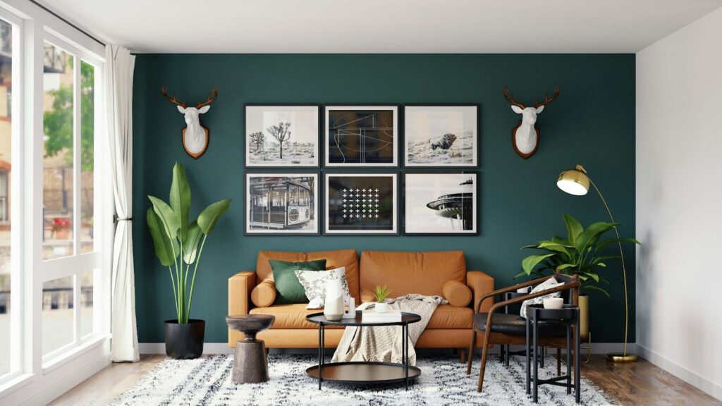 Stylish living room with a green accent wall, artwork, plants, and a cozy brown sofa with modern decor.