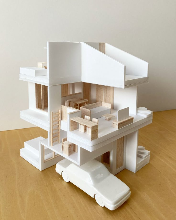 Modern architectural model with open layout design and white minimalist style, featuring a detailed car model.