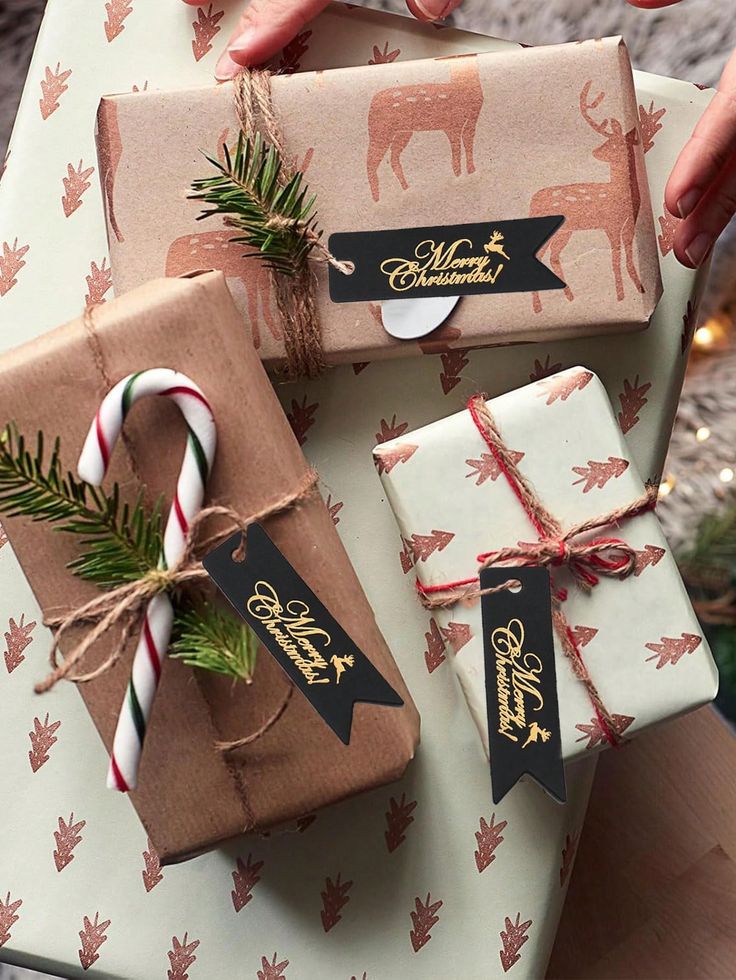 Christmas gifts wrapped in festive paper with deer patterns, adorned with tags saying Merry Christmas and candy canes.