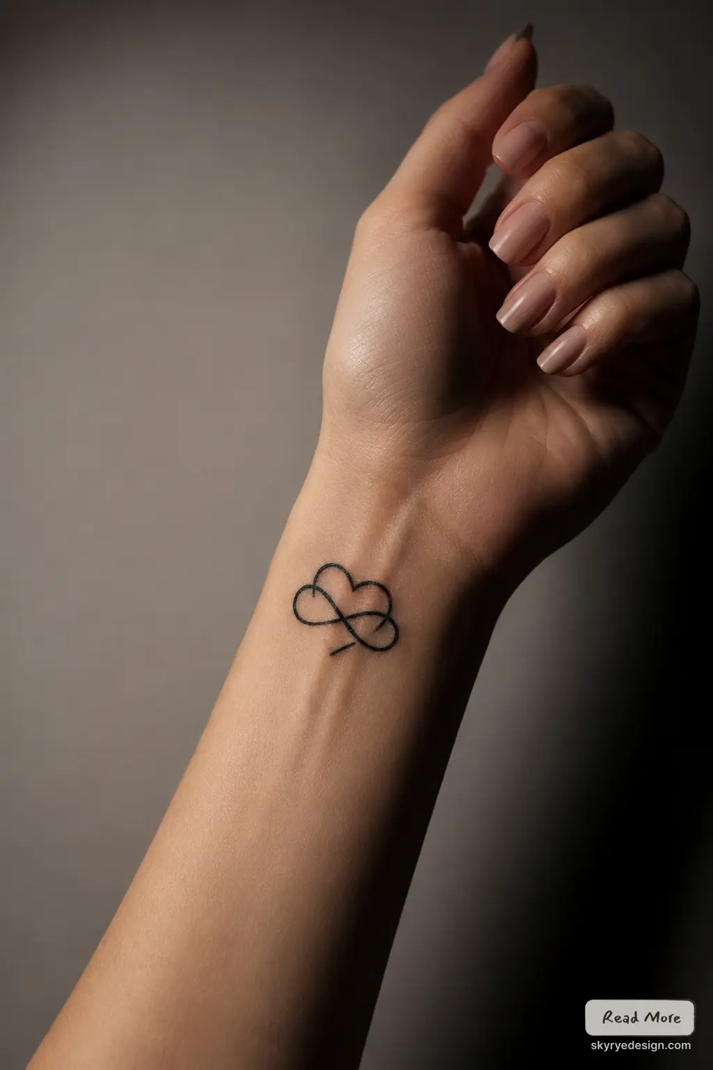 infinity heart Minimalist black heart-infinity wrist tattoo on female hand with natural nails, close-up on forearm | Sky Rye Design Minimalist black heart-infinity wrist tattoo on female hand with natural nails, close-up on forearm