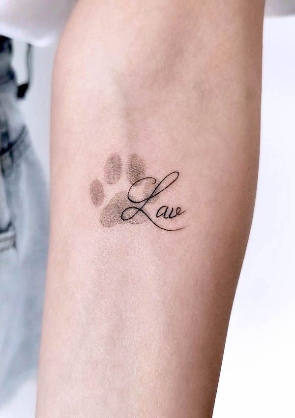 Tattoo of a paw print with Love script on an arm, symbolizing affection for animals.