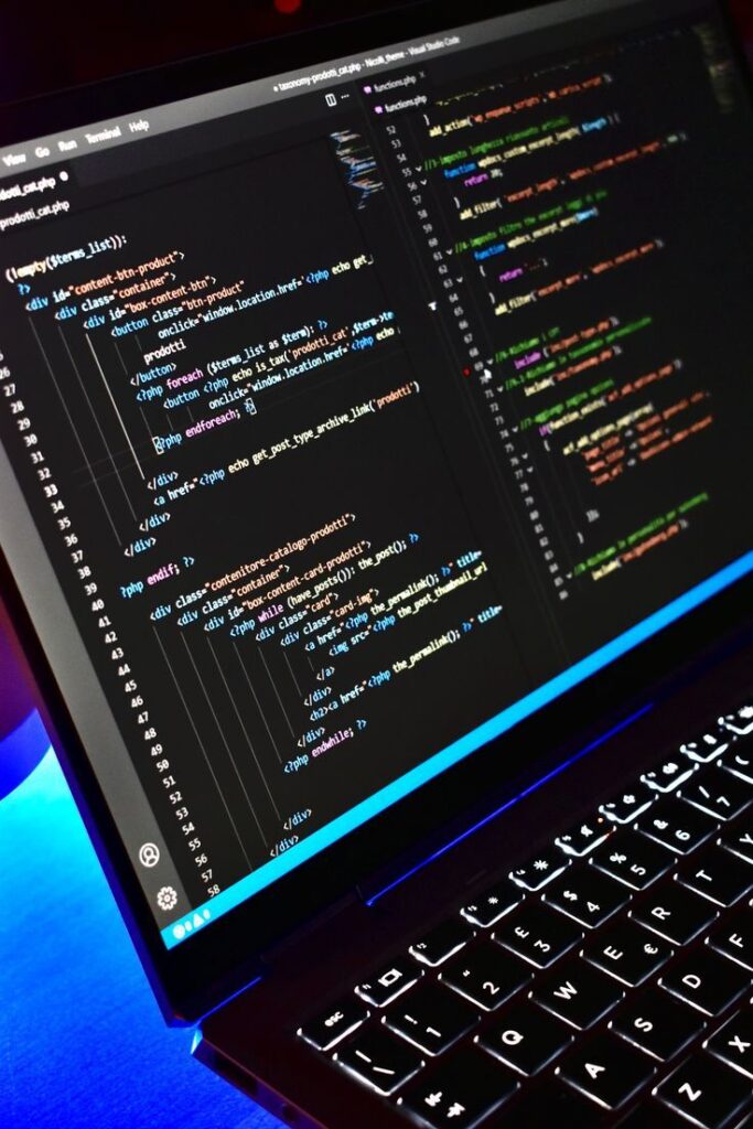 Close-up of laptop screen with colorful code snippets in a dark programming environment.