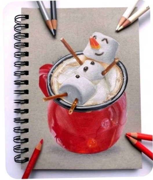 Drawing of marshmallow snowmen in cocoa on a red mug sketch, surrounded by colored pencils.