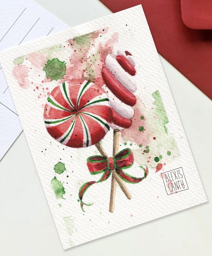 Festive watercolor art of red and green holiday lollipops with a decorative bow, perfect for Christmas decoration.