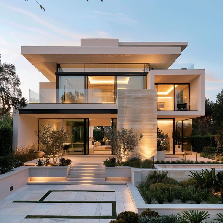 Modern luxury home with glass facade, sleek architectural design, and landscaped gardens at dusk.