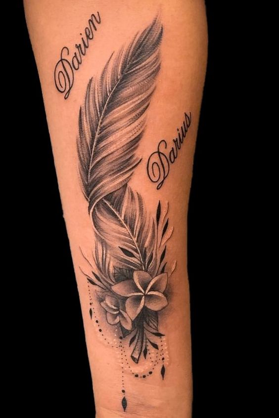 Feather tattoo design with flowers and beads on forearm, featuring intricate shading and two names entwined.