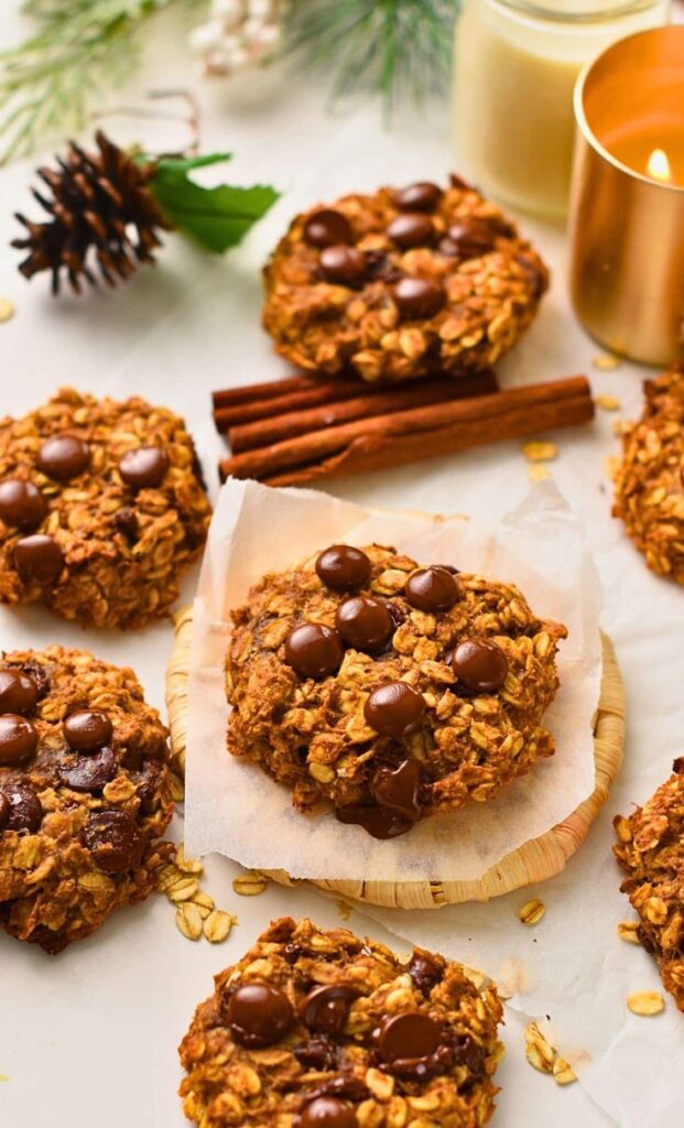 Delicious oatmeal chocolate chip cookies with cinnamon sticks, perfect for a cozy holiday treat.