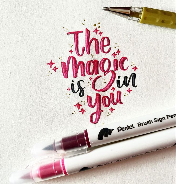 Inspirational hand-lettered quote The magic is in you with colorful pens on paper.