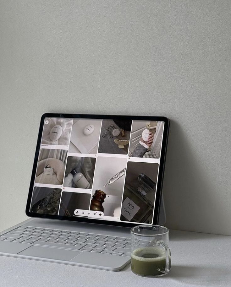 iPad displaying aesthetic mood board with coffee cup on desk.