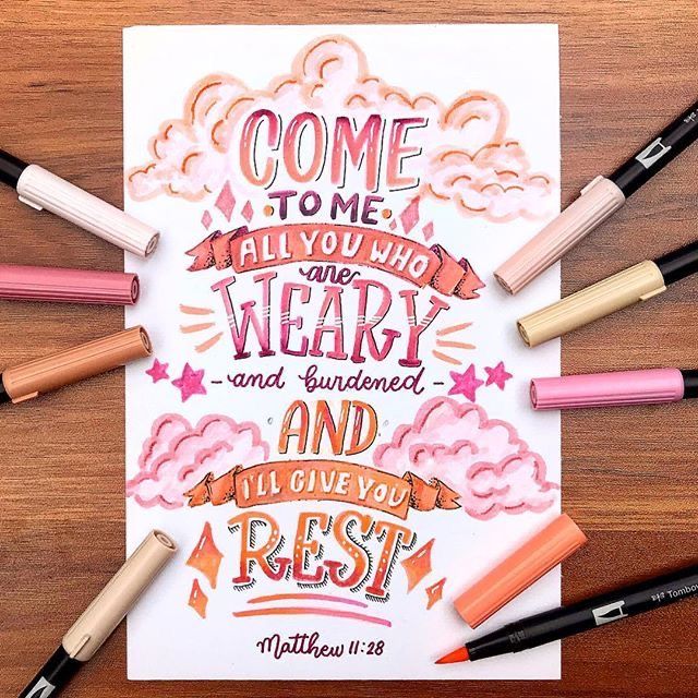 Hand-lettered Matthew 11:28 Bible verse with colorful pens and clouds, offering rest and comfort.