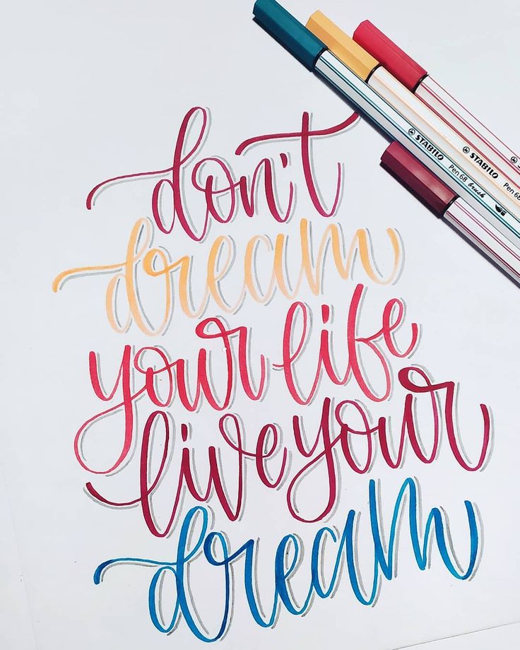 Inspirational hand-lettering quote: Don't dream your life, live your dream with colorful pens.