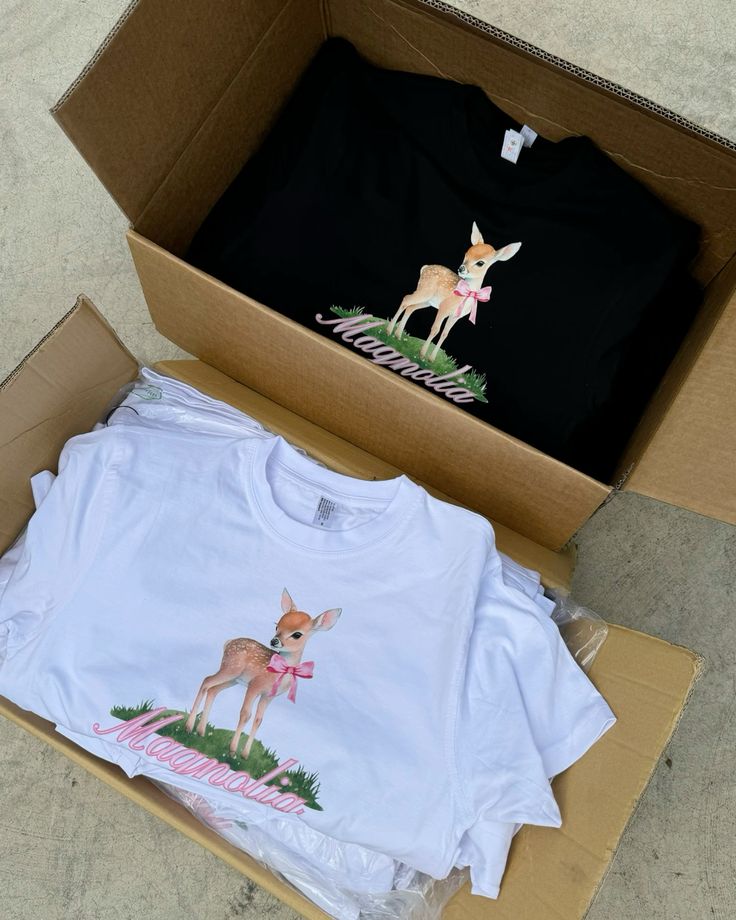 Boxed T-shirts featuring a cute fawn graphic and Magnolia text, available in black and white.