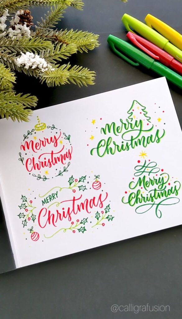 Festive Merry Christmas calligraphy with holiday decorations and markers on a table.