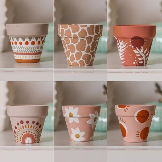 Hand-painted terracotta pots with unique designs and patterns, perfect for adding a creative touch to your decor.