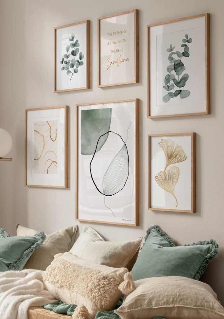 Cozy living room with framed botanical and abstract art above a sofa with green and beige cushions.