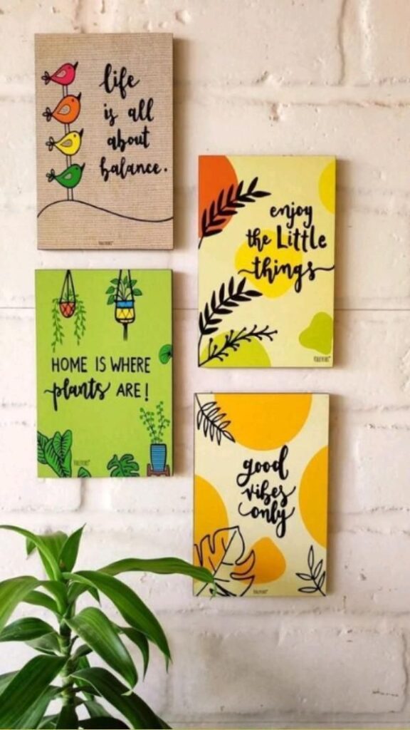 Inspirational wall art on a brick background featuring motivational quotes and a leafy plant in the foreground.