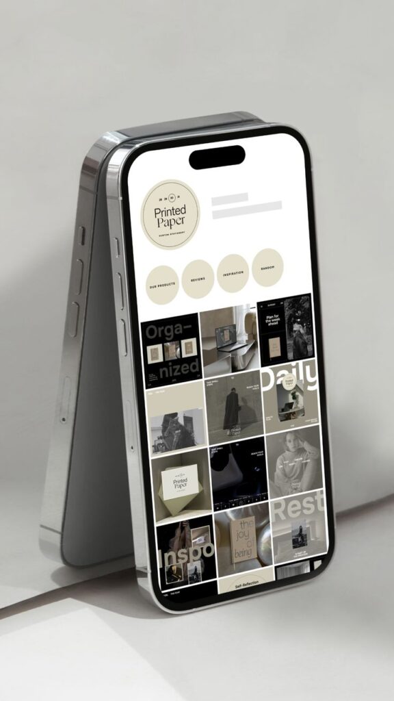 Smartphone showcasing Printed Paper website design with product images and inspiration category.